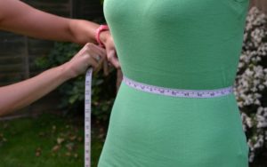 measuring a waist line using a measuring tape