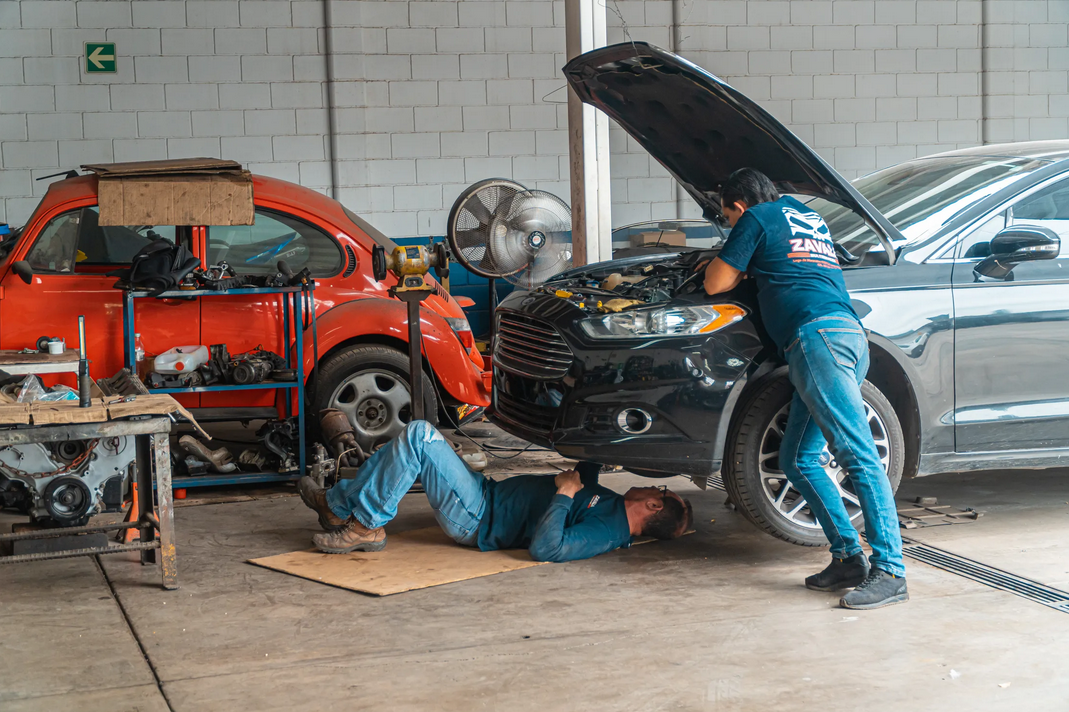 mechanics fixing a car